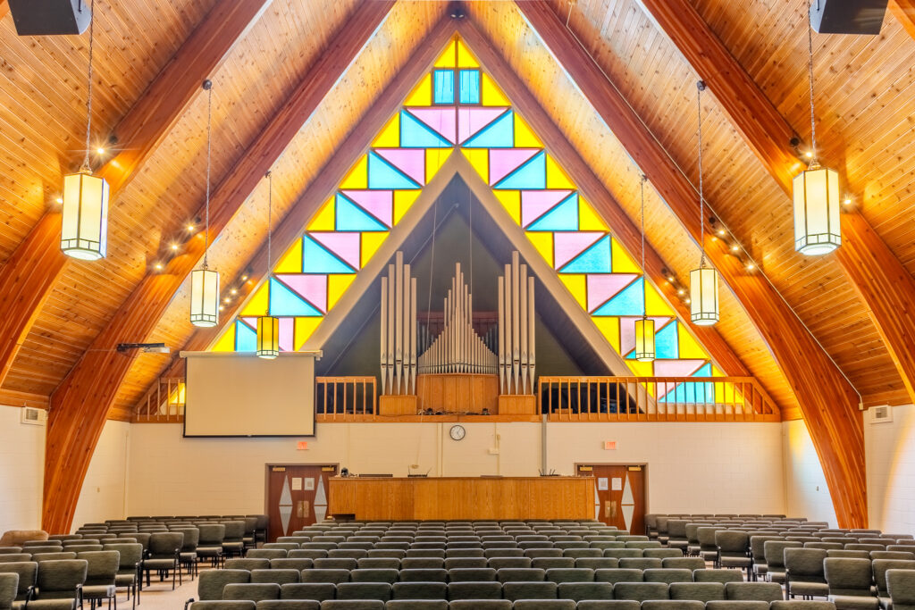 The sanctuary stained-glass window and pipe organ at Aylmer CRC