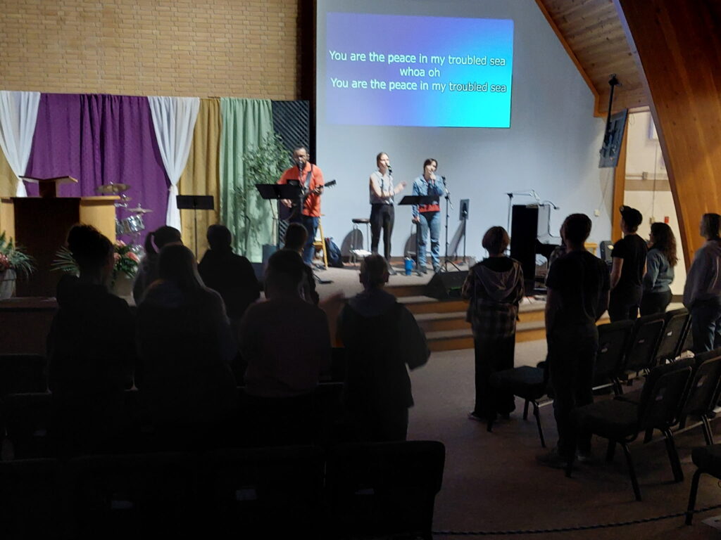 Worship team leading a service as the congregation gathers