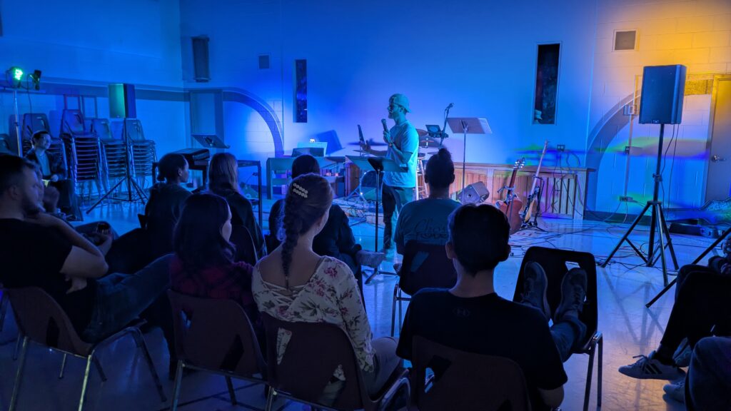 Evening worship gathering lit in blue