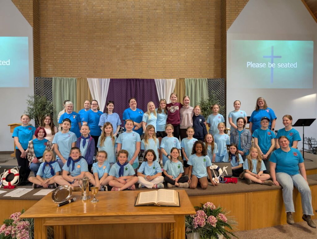 Children’s group in matching blue shirts on the church stage